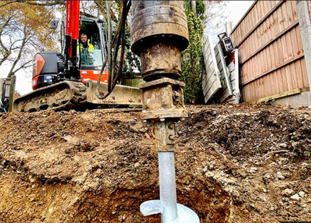 Helical pile driven with a hydraulic torque head